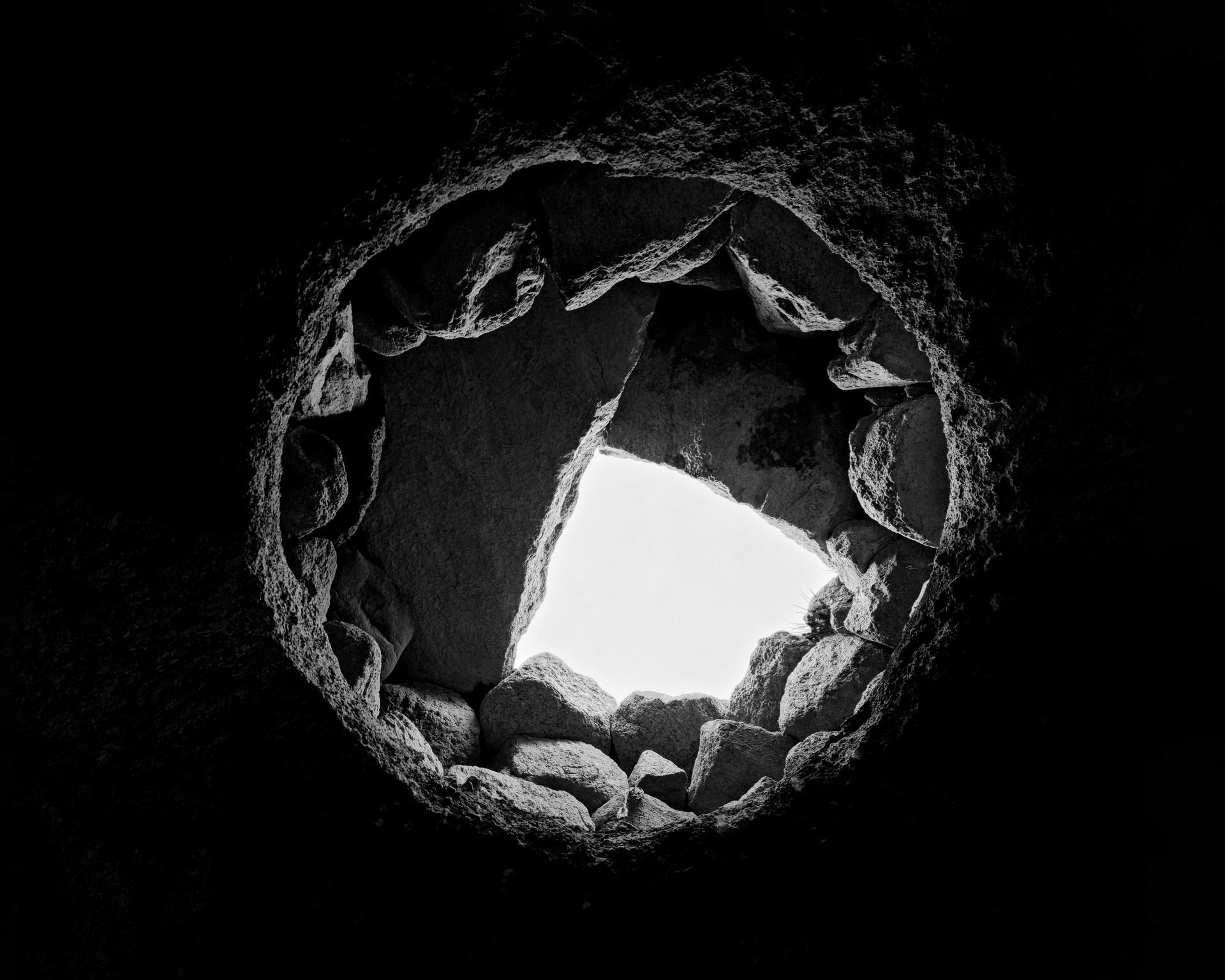 This collection comprises a selection of striking monochrome photographs capturing abandoned houses in the historical village of HileVar, situated near Kandovan in the East Azarbaijan Province of Iran. The houses were once inhabited by people who lived underground in the heart of the mountain, over a thousand years ago, before the establishment of Kandovan village and the Mongol invasion of the area. Today, these houses stand as nothing more than well-designed caves, evoking a sense of the region's rich history and the passage of time.